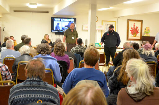 Fire Marshal and floodplain administrator Phil Cecere answers questions with deputy floodplain administrator Greg Ballard on Monday night in Brinnon. (Elijah Sussman/Peninsula Daily News)