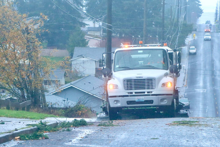 A street sweeper on I Street in Port Angeles cleans up the street along the curbs of all the debris that blew down during Tuesday evening’s storm. Thousands were without power at the peak of the storm. (Dave Logan/for Peninsula Daily News)