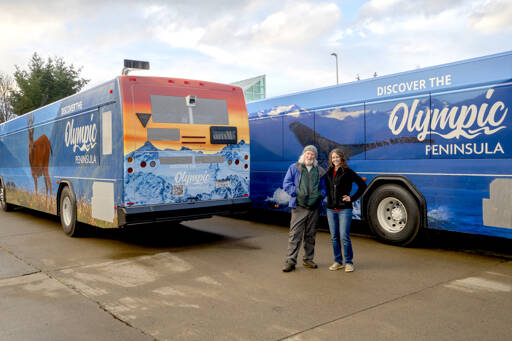 Photographers John Gussman, left, and Becky Stinnett contributed their work to Clallam Transit System’s four wrapped buses that feature wildlife and landscapes on the Olympic Peninsula. The project was created to promote tourism and celebrate the beauty of the area. (Paula Hunt/Peninsula Daily News)