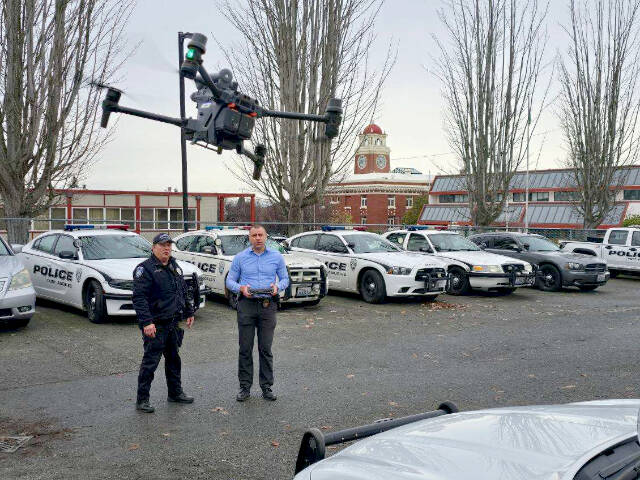 Code Enforcement Officer Derek Miller, left, watches Detective Trevor Dropp operate a DJI Matrice 30T drone  outside the Port Angeles Police Department. (Port Angeles Police Department)