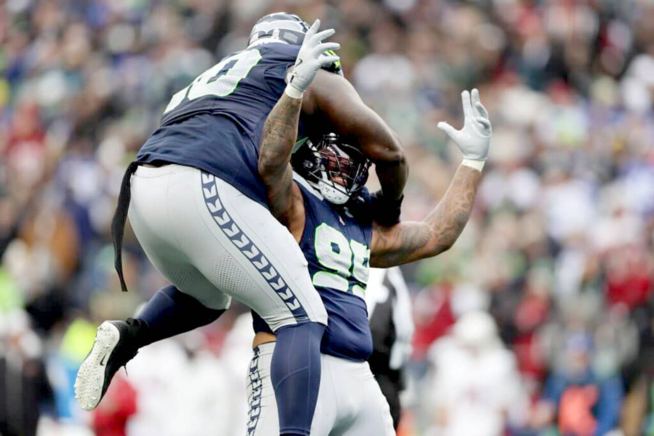 Seattle's Jarran Reed (90) and Leonard Williams (99) celebrate a big defensive play against the Arizona Cardinals at Lumen Field in Seattle on Sunday. Seattle won 16-6 to take over first place in the NFC West.
(Rio Giancarlo/Getty Images)