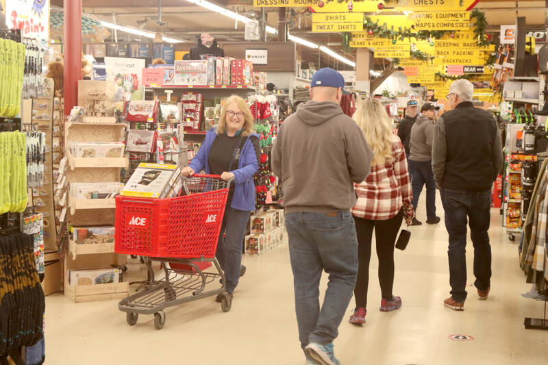 Janet Lucas, left, finds a special purchase of a “mail manager” at Swains early Friday morning. Black Friday shoppers descended on the Port Angeles store at 8 a.m. There were dozens of early risers who went looking for special bargains on one of the biggest shopping days of the year. (Dave Logan/for Peninsula Daily News)