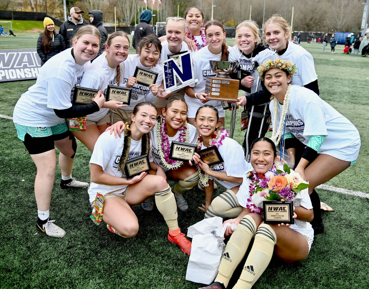 The Peninsula College women’s soccer team celebrates on Nov. 17 in Tukwila after winning the Northwest Athletic Conference championship. (Jay Cline/Peninsula College)