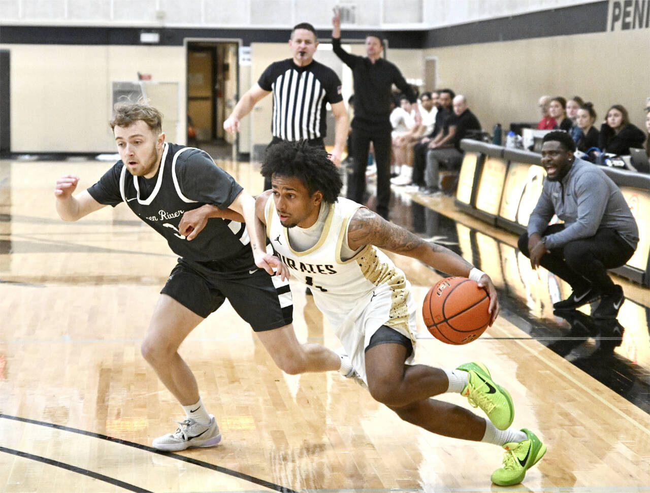 Peninsula College’s Patrick Odingo drives against Green River’s Maddux Albers on Tuesday in Port Angeles. (Jay Cline/Peninsula College)