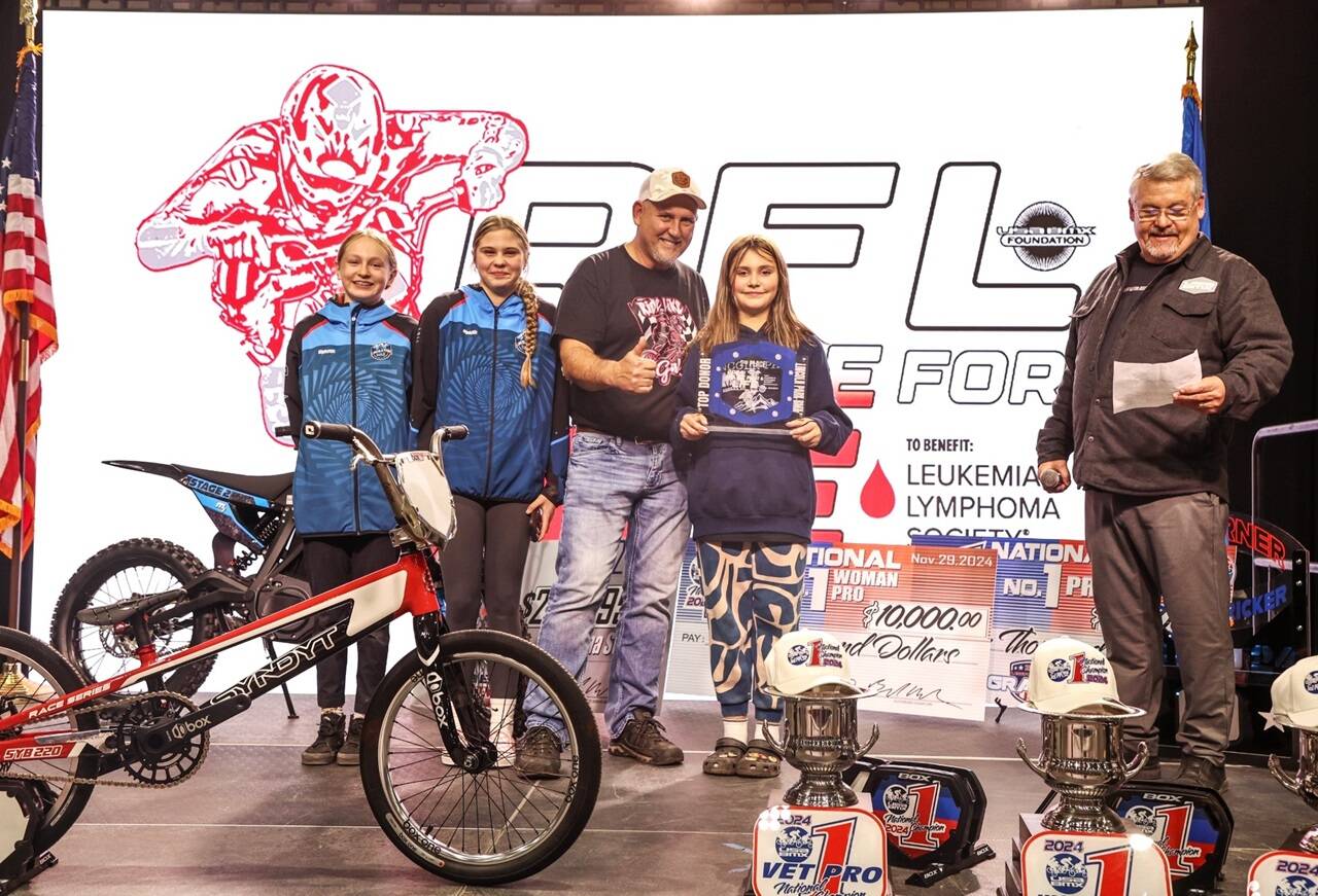 From left, Lincoln Park BMX's Teyah Elofson-Cross, Kylin Weitz, track operator Sean Coleman and Chloe Holloway represented the Olympic Peninsula at the BMX Grand Nationals last weekend in Tulsa, Okla. At right is USABMX president BA Anderson. Wietz won a first-place medal at Grand Nationals. (Lincoln Park BMX)