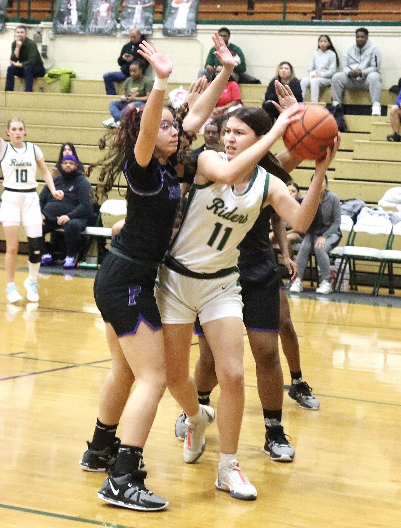 Port Angeles’ Lindsay Smith (11) battles against Renton in a postseason game last year. Smith started the season with 19 points, 18 rebounds in her opening game. (Keith Thorpe/Peninsula Daily News)