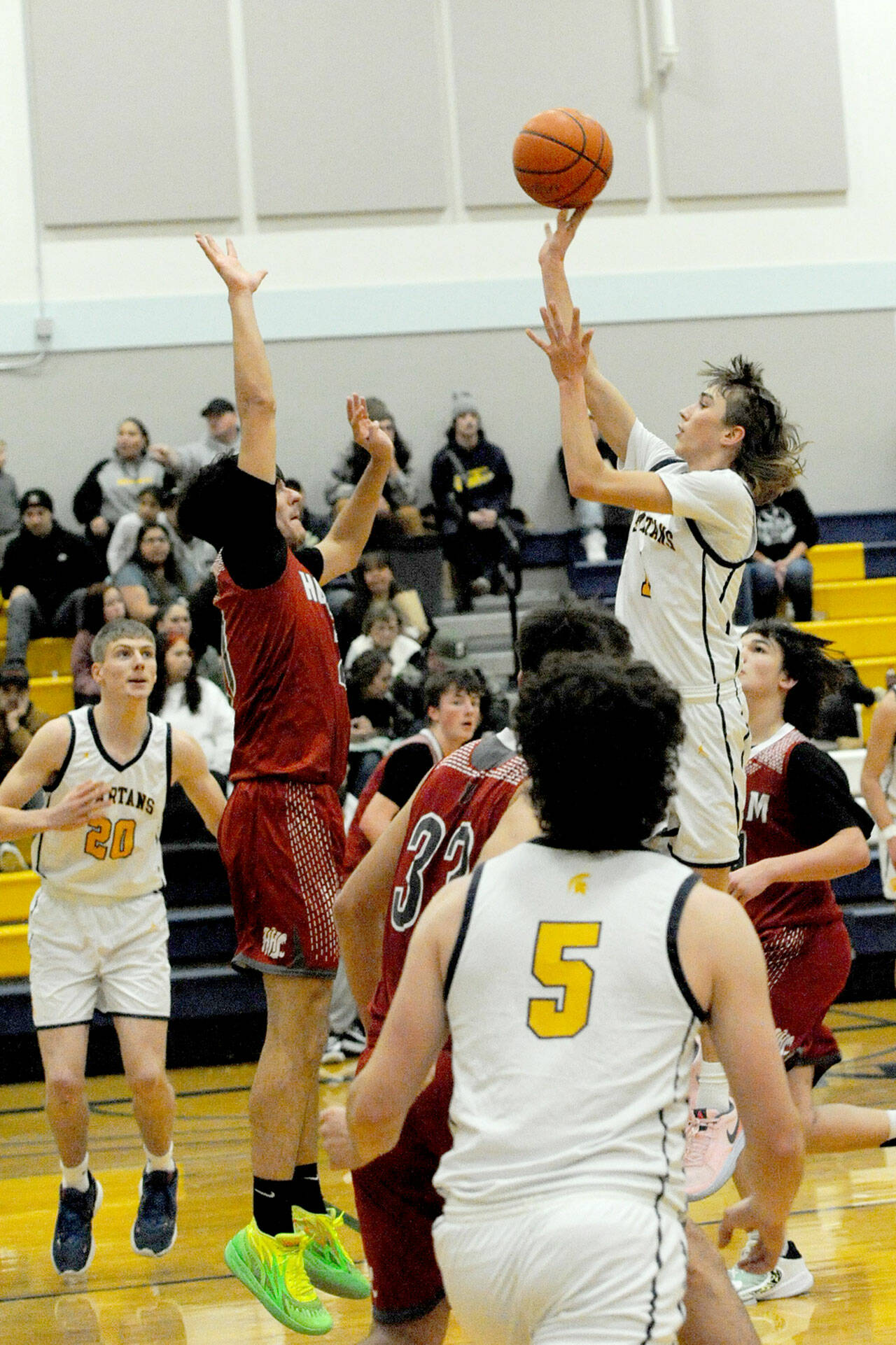 Lonnie Archibald/for Peninsula Daily News Forks’ Kyle Lohrengel scores over Hoquiam’s Chance LaBounty during a 2023-24 contest in the Spartans gym. Lohrengel returns to play point guard for Forks.