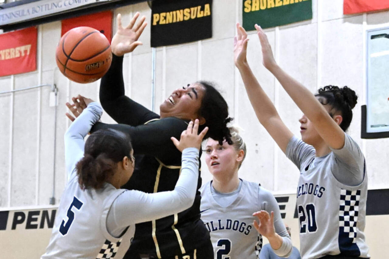 Peninsula College's Jelissa Julmist is surrounded by three Bellevue defenders Saturday in Port Angeles. (Jay Cline/Peninsula College)