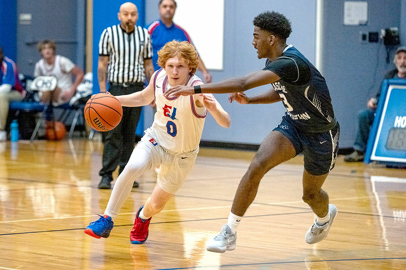 Steve Mullensky/for Peninsula Daily News

East Jefferson's Traycen Brown drives while defended by Cascade Christian's Josiah Gopaul during a 2023-24 contest at Chimacum High School.