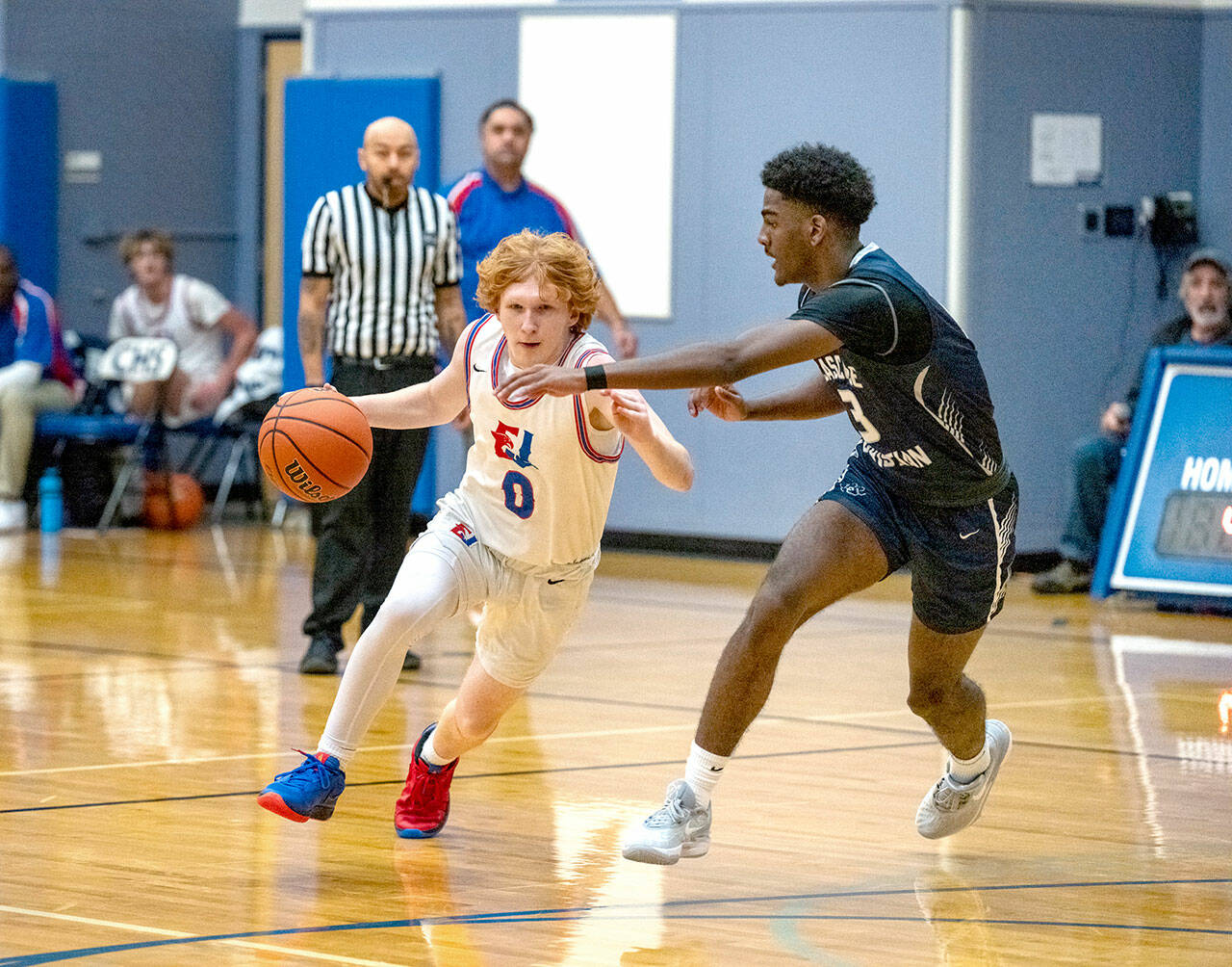 Steve Mullensky/for Peninsula Daily News East Jefferson’s Traycen Brown drives while defended by Cascade Christian’s Josiah Gopaul during a 2023-24 contest at Chimacum High School.