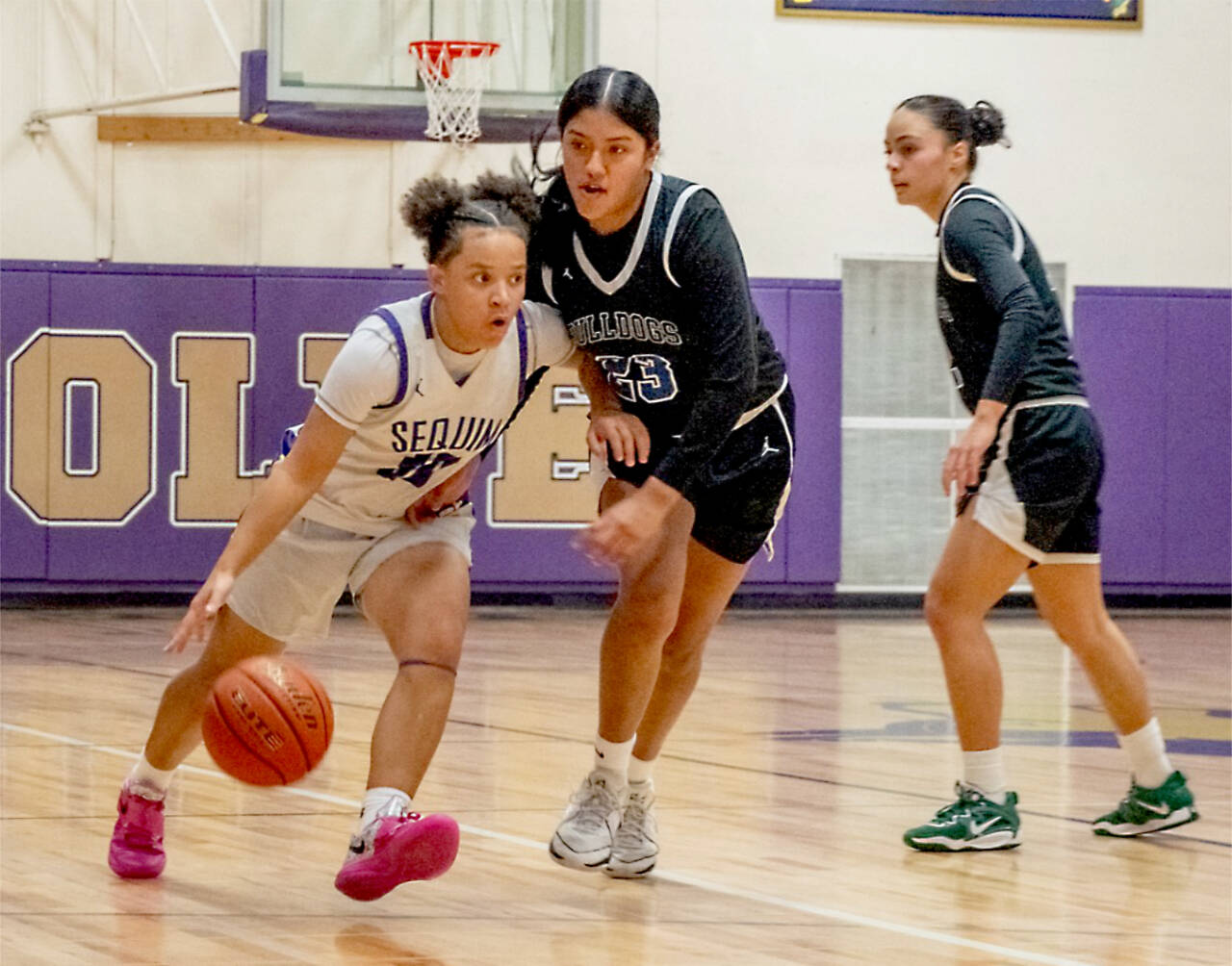 Sequim guard Bobbi Mixon drives around a pair of North Mason defenders Tuesday in Sequim. (Emily Mathiessen/Olympic Peninsula News Group)