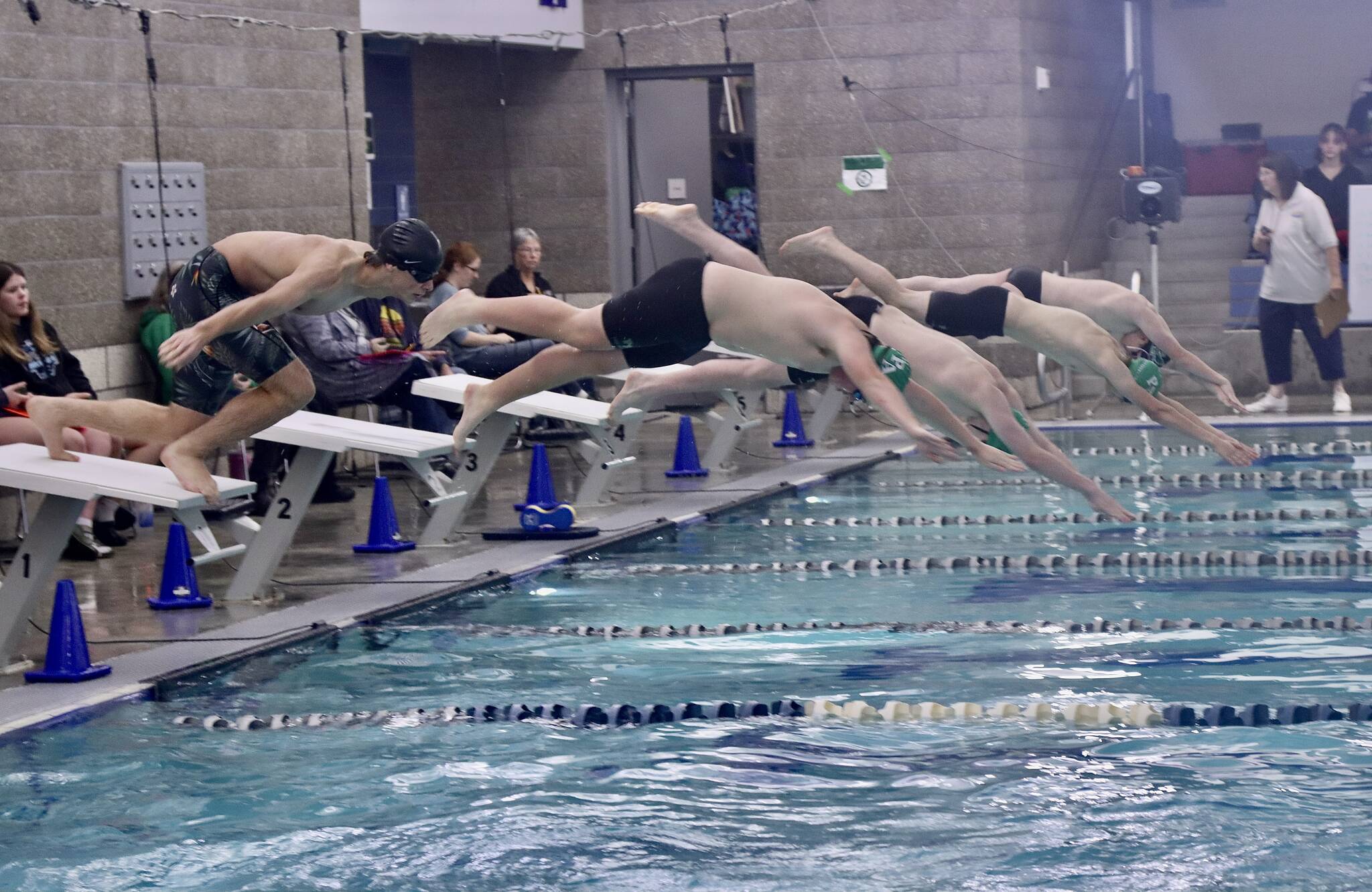 Dave Logan (2)/for Peninsula Daily News 
Port Angeles (green caps) and Klahowya swimmers dive into the pool at Shore Aquatic Center for the 200-yard freestyle. The Roughriders won the season-opening Olympic League boys swim meet 147-30 over the Eagles.