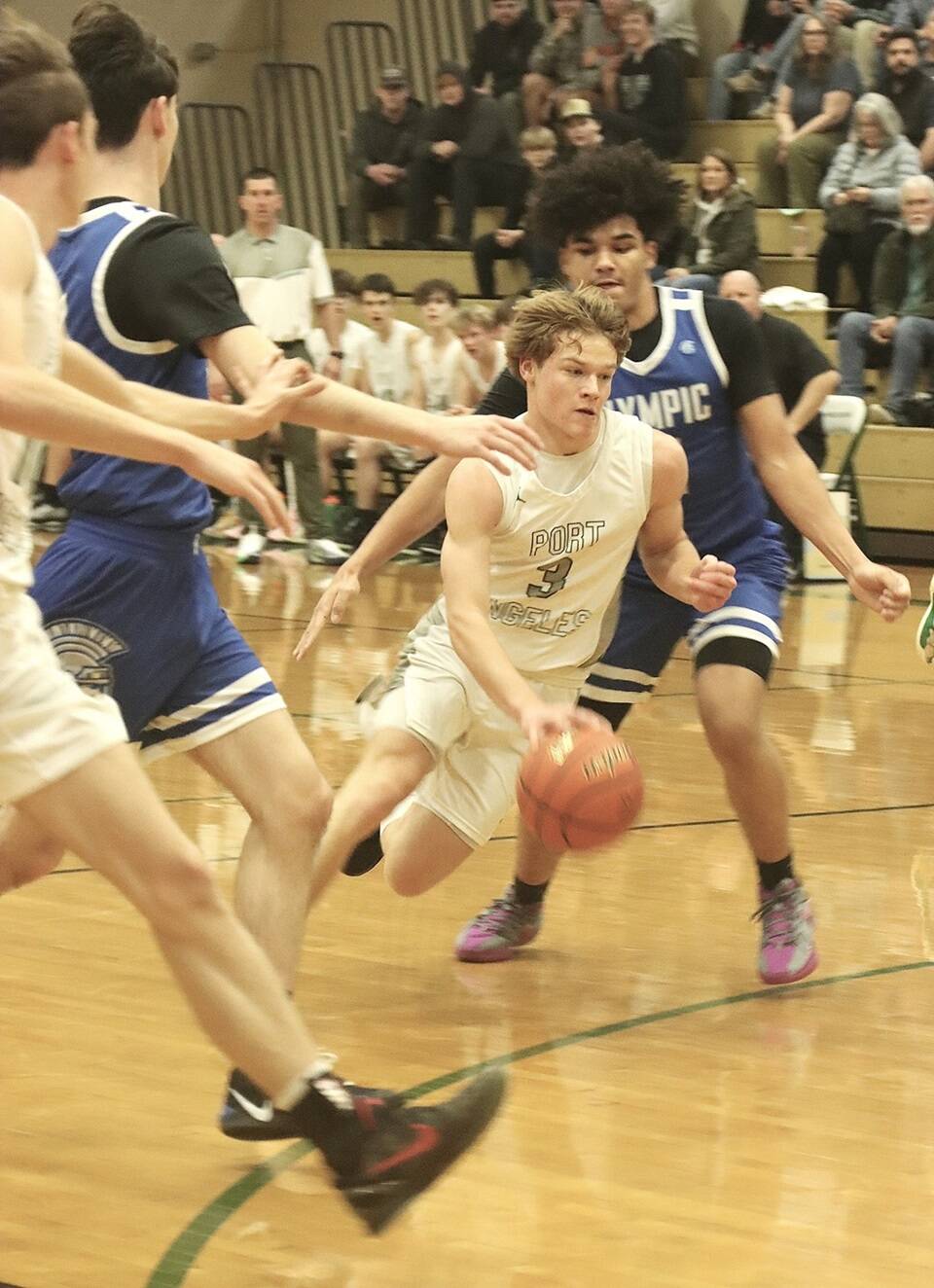 Port Angeles’ Gus Halberg drives the lane against Olympic on Friday night. Halberg had 25 points and went to the free-throw line 17 times in a 75-40 Port Angeles victory. (Dave Logan/for Peninsula Daily News)