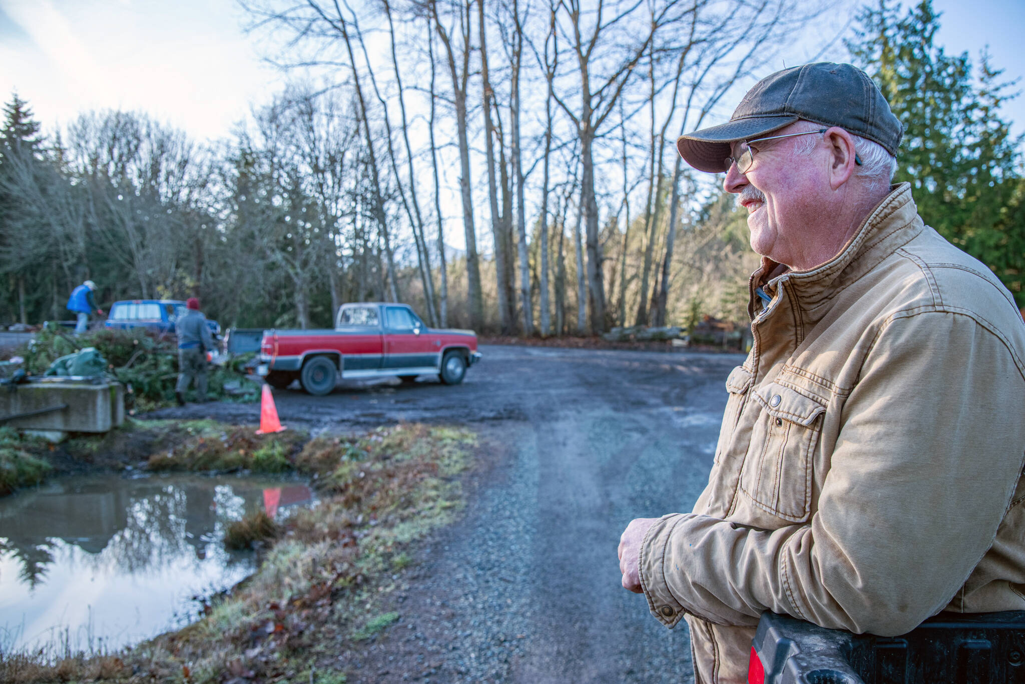 Lazy J Tree Farm owner Steve Johnson has lived his whole life on the farm and says he likes to tell people, “I have the same telephone number I was born with.” In the distance, people unload yard waste to be chopped into mulch or turned into compost. Christmas trees are received free of charge, regardless of where they were purchased. (Emily Matthiessen/Olympic Peninsula News Group)