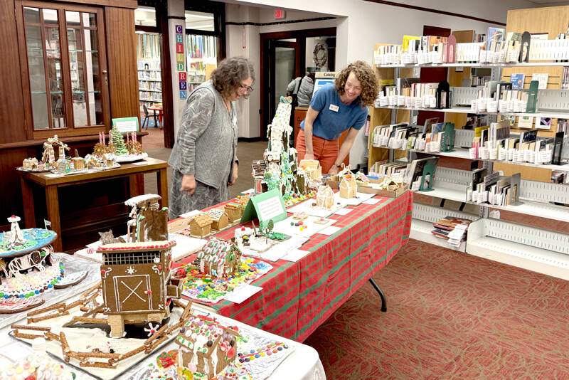 Library crew members Judith Bows, left, and Suzy Elbow marvel at the Uptown Gingerbread Contest entries at the Port Townsend Library. (Diane Urbani de la Paz/for Peninsula Daily News)