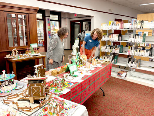 Library crew members Judith Bows, left, and Suzy Elbow marvel at the Uptown Gingerbread Contest entries at the Port Townsend Library. (Diane Urbani de la Paz/for Peninsula Daily News)