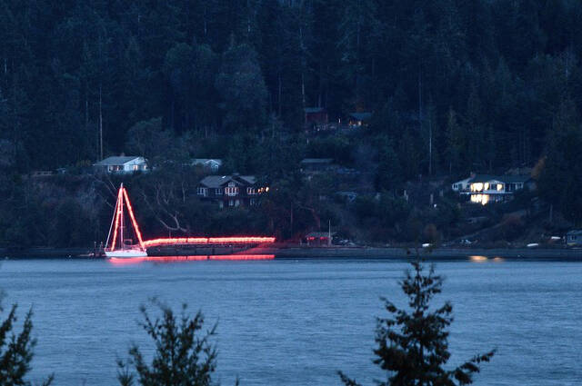 For 20-plus years, Bob and Kelly Macaulay have decorated their boat and dock off East Sequim Bay Road for Christmas, seen here more than a mile away. However, the couple sold their boat earlier this year. (Doug Schwarz)