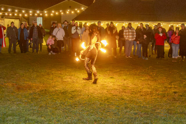 Steve Mullensky/for Peninsula Daily News
A fire dancer from Port Townsend's Fire Dance Collective, performs in front of spectators during the 2nd Annual Solstice Bonfire hosted by Jefferson County 4-H at the Jefferson County Fairgrounds on Saturday.