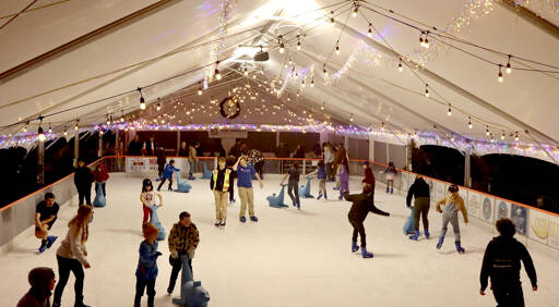 Skaters glide across the Winter Ice Village on Front Street in downtown Port Angeles. The Winter Ice Village, operated by the Port Angeles Chamber of Commerce, is open daily from noon to 9 p.m. through Jan. 5. (Dave Logan/for Peninsula Daily News)