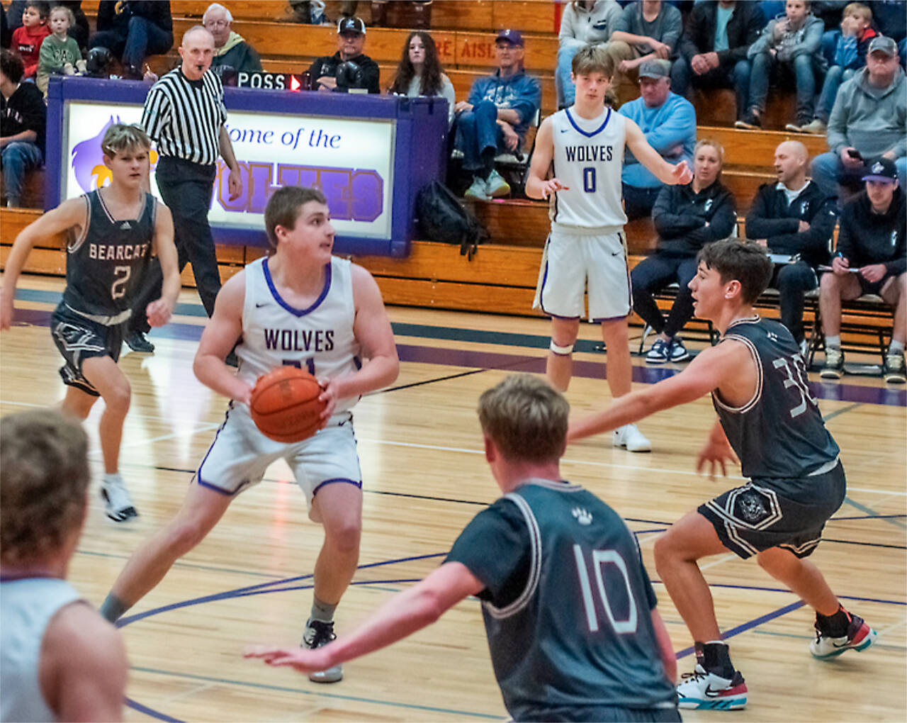 Sequim's Braydan White (21) drives the lane as Ethan Melnick (0) is also in on the play Saturday in Sequim against W.F. West. The Wolves won 59-42. (Emily Matthiessen/Olympic Peninsula News Group)