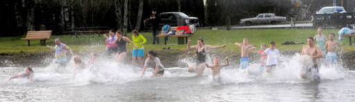 About 20 people took to the waters of Lake Pleasant on New Year’s morning at the Clallam County park during the Polar Bear plunge. (Lonnie Archibald/for Peninsula Daily News)