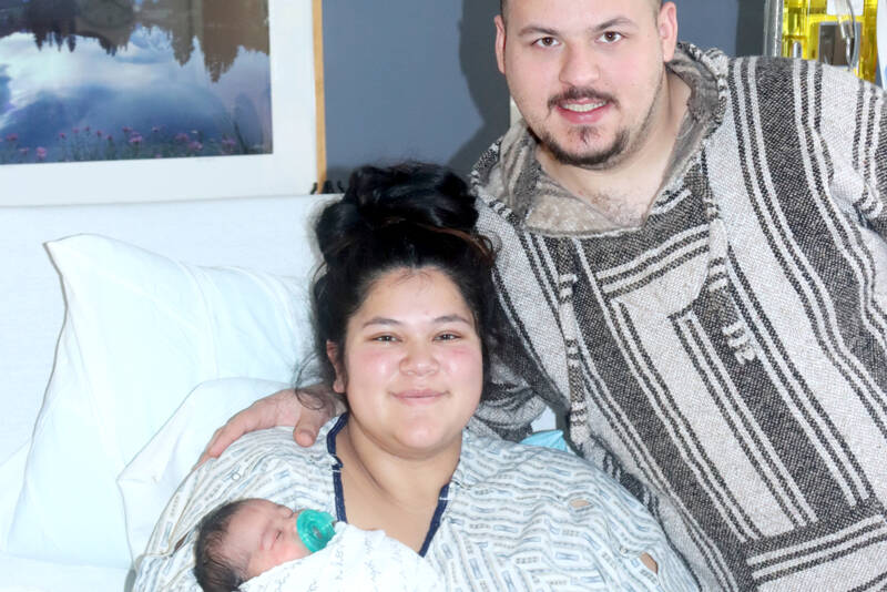 Angel Beadle holds Phoebe Homan, the first baby born on the North Olympic Peninsula in 2025. Father David Homan stands by their side in a room at Olympic Medical Center in Port Angeles. (Dave Logan/for Peninsula Daily News)