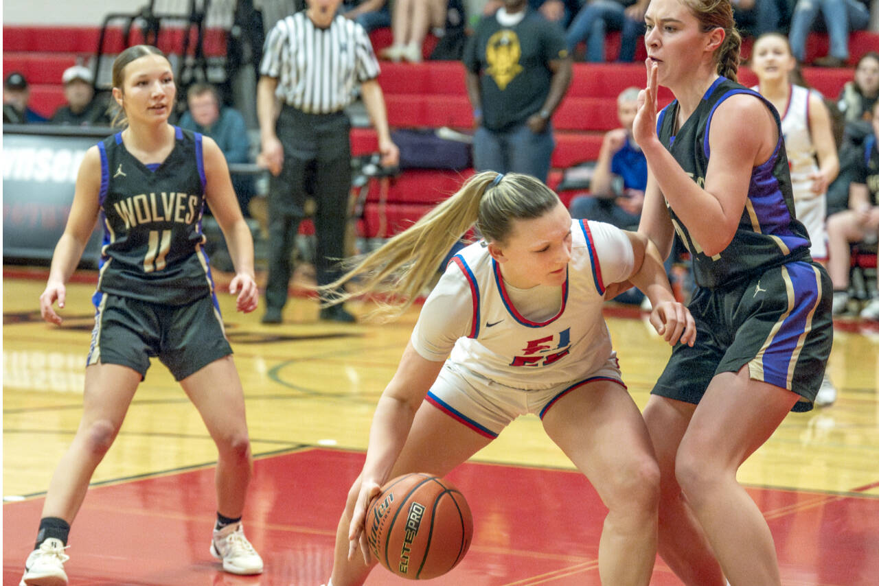 East Jefferson Teri Wiley battles for inside position against the defense of Sequim's Hailey Wagner. Also in on the play is Sequim's Kiley Winter. (Steve Mullensky/for Peninsula Daily News)