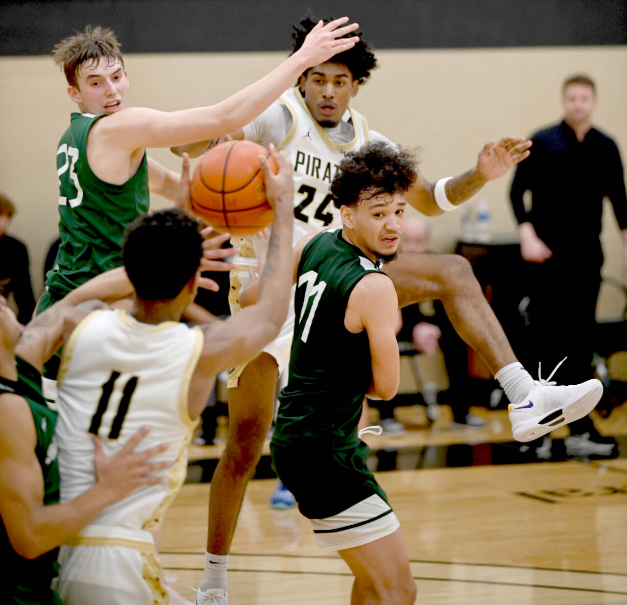 Peninsula College’s Jaiden Blackmon (24) looks for the ball from teammate Antonio Odum (11). Blackmon led the shorthanded Pirates in scoring in two straight games this weekend. (Rick Ross/Peninsula College)