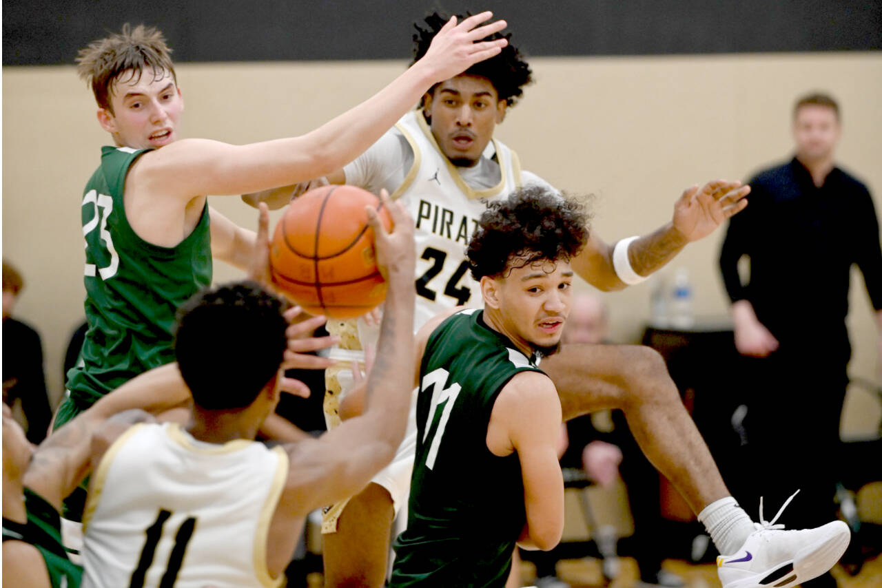 Peninsula College's Jaiden Blackmon (24) looks for the ball from teammate Antonio Odum (11). Blackmon led the shorthanded Pirates in scoring in two straight games this weekend. (Rick Ross/Peninsula College)