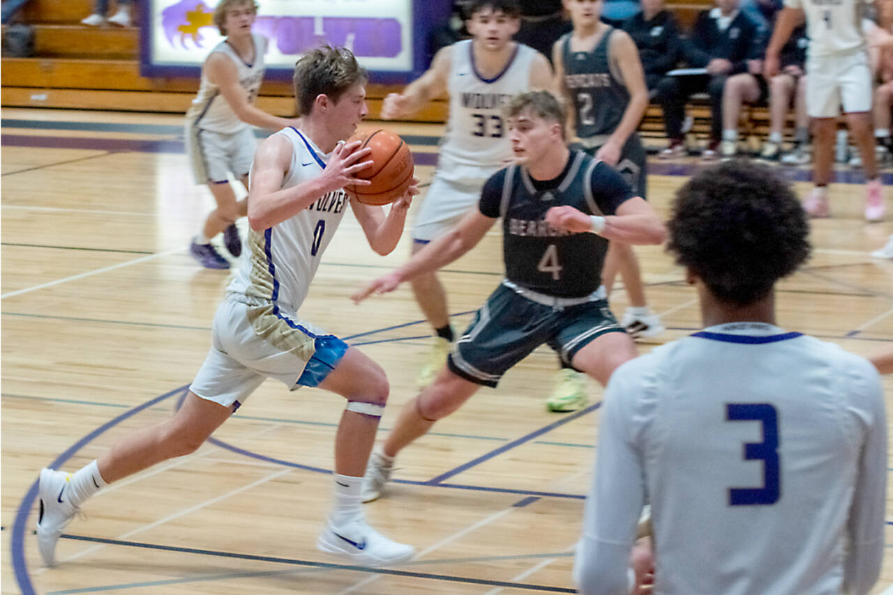 Ethan Melnick of Sequim (0) drives against W.F. West late last year. Also in on the play are Solomon Sheppard (3) and Jamison Gray (33). (Emily Mathiessen/Olympic Peninsula News Group)