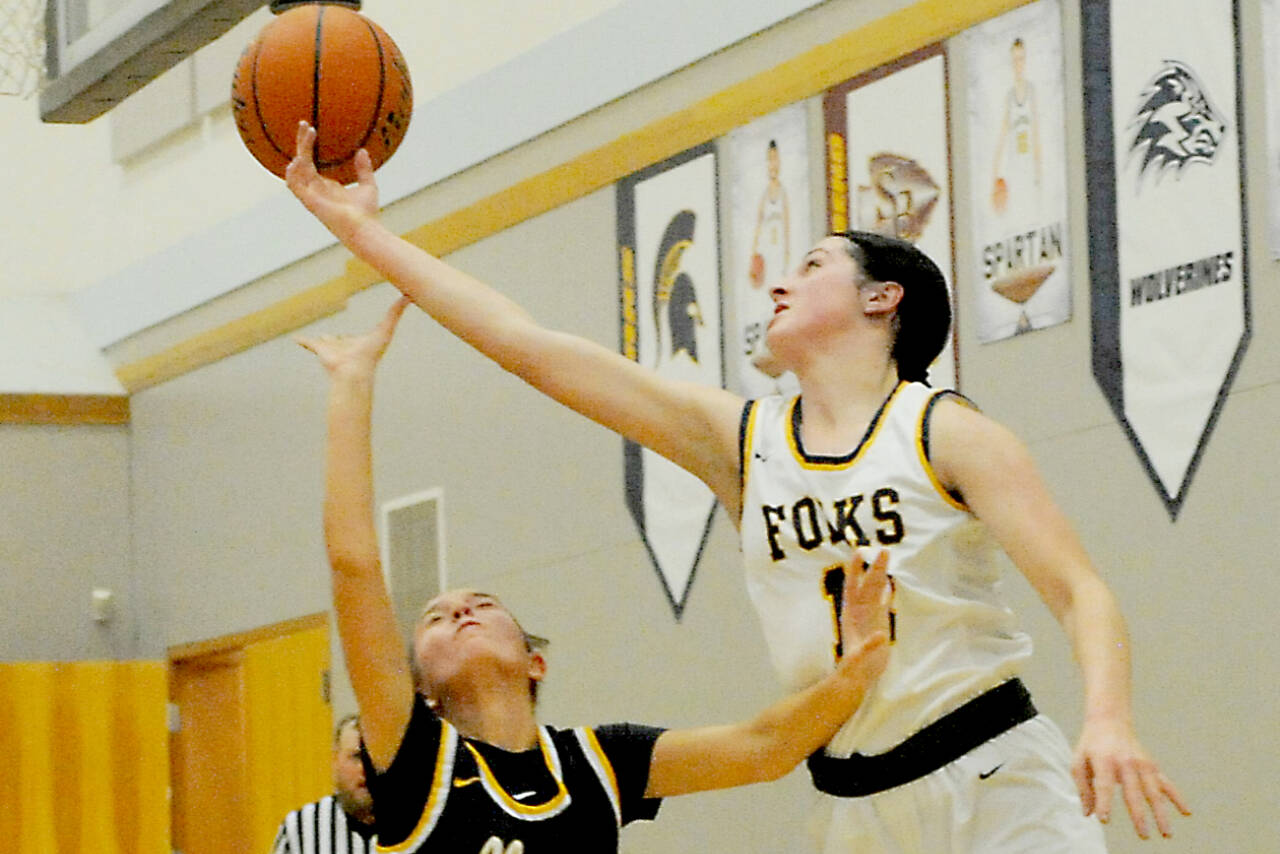 Chloe Gaydeski of Forks battles for a rebound over Ilwaco's Madison Smolorak on Monday in Forks. The Spartans won their Pacific 2B League opener 63-23. (Lonnie Archibald/for Peninsula Daily News)