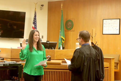 Clallam County Superior Court Judge Elizabeth Stanley is sworn in by Judge Simon Barnhart on Thursday at the Clallam County Courthouse. Stanley, elected in November to Position 1, takes the role left by Judge Lauren Erickson, who retired. Barnhart and Judge Brent Basden also were elected in November. All three ran unopposed. (Dave Logan/for Peninsula Daily News)