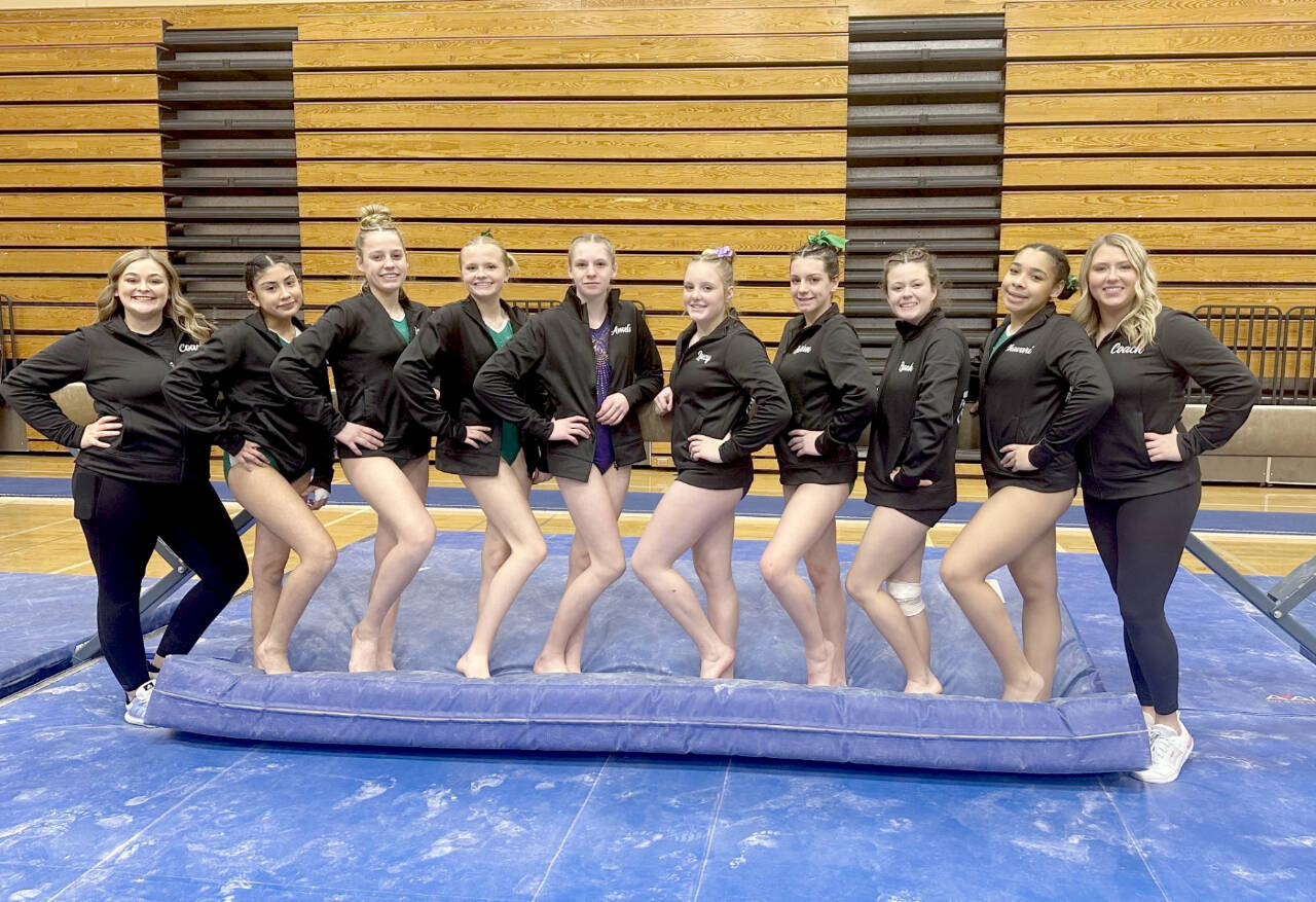 The Port Angeles and Sequim gymnastics team. From left, Assistant Coach Laura Rooney, Denise Galvan (PAHS), Lexi Possinger (PAHS), Mya Callis (PAHS), Amelie Martin (Sequim), Lucy Spelker (Sequim), Lillian Sutherland (PAHS), Ryah Deleon (PAHS), Shavari Epps (PAHS) and head coach Elizabeth DeFrang. (PA/Sequim Gymnastics)