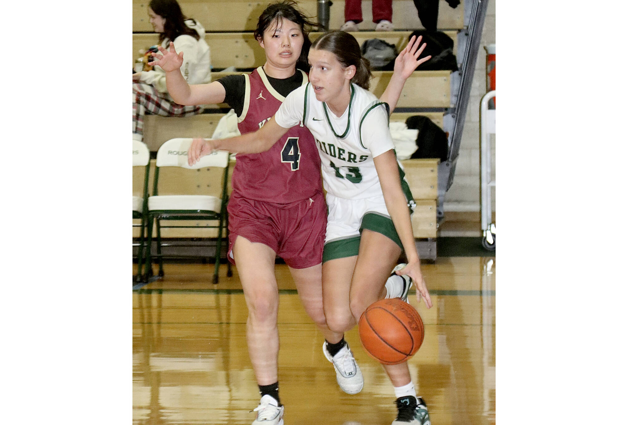 Port Angeles' Morgan Politika drives down the court against the defense of Kingston's Chihiro Yanase on Tuesday in Port Angeles. (Dave Logan/for Peninsula Daily News)