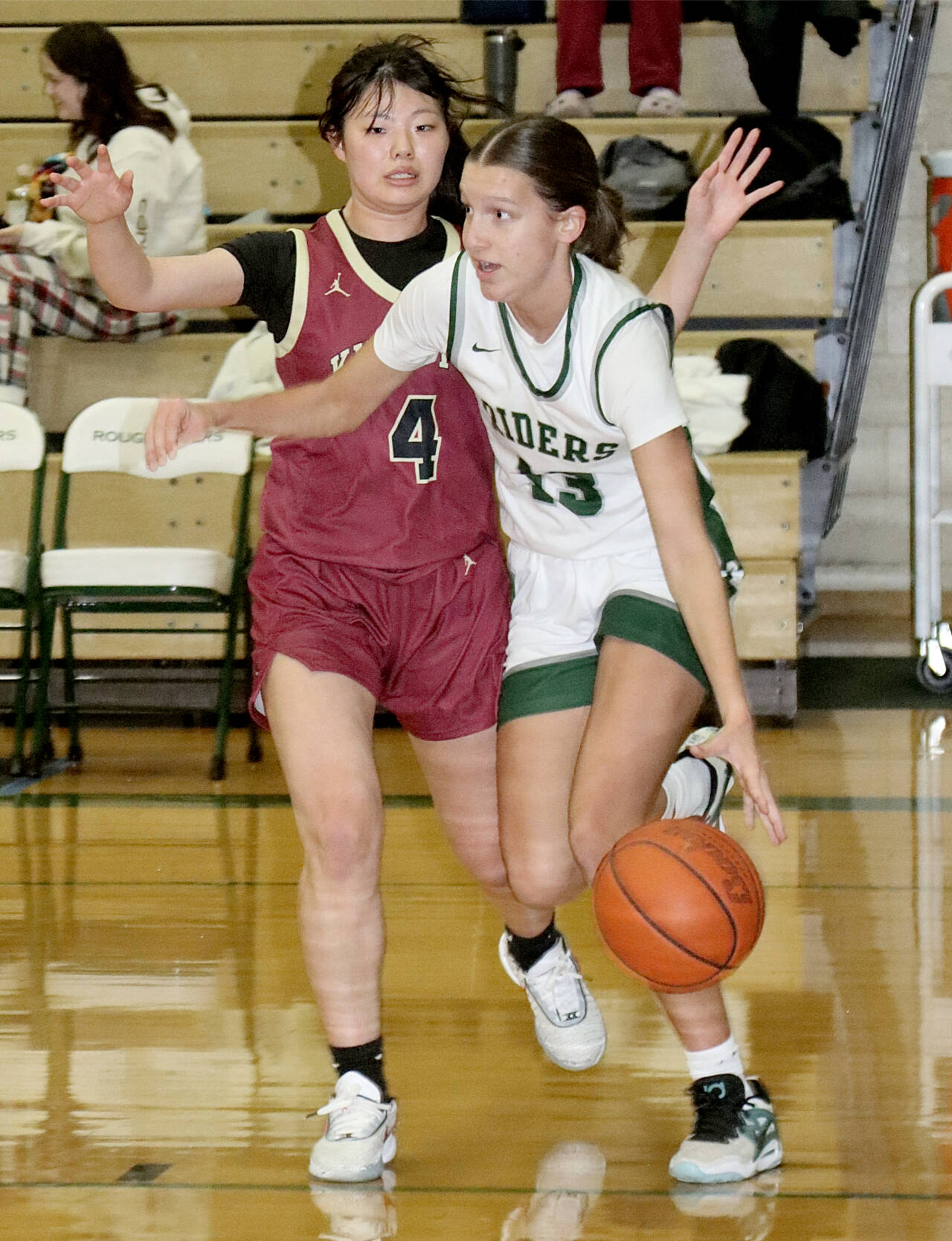 Port Angeles’ Morgan Politika drives down the court against the defense of Kingston’s Chihiro Yanase on Tuesday in Port Angeles. (Dave Logan/for Peninsula Daily News)