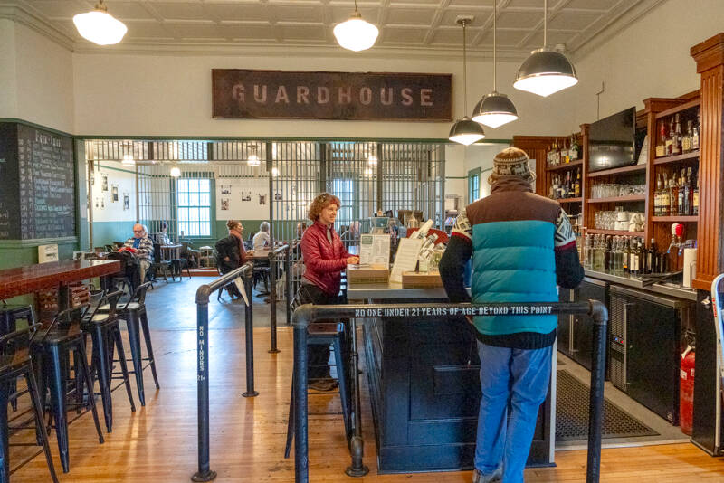 Holly Hildreth of Port Townsend, center, orders a latte for the last time at the Guardhouse, a cafe at Fort Worden State Park, on Wednesday. At noon the popular cafe was to close permanently, leaving an empty space for food, drinks and restroom facilities in the park. (Steve Mullensky/for Peninsula Daily News)