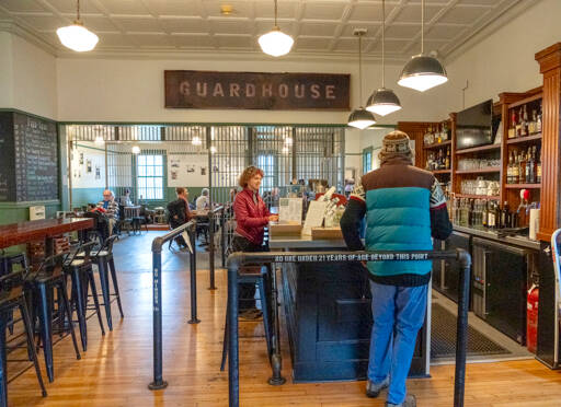 Holly Hildreth of Port Townsend, center, orders a latte for the last time at the Guardhouse, a cafe at Fort Worden State Park, on Wednesday. At noon the popular cafe was to close permanently, leaving an empty space for food, drinks and restroom facilities in the park. (Steve Mullensky/for Peninsula Daily News)