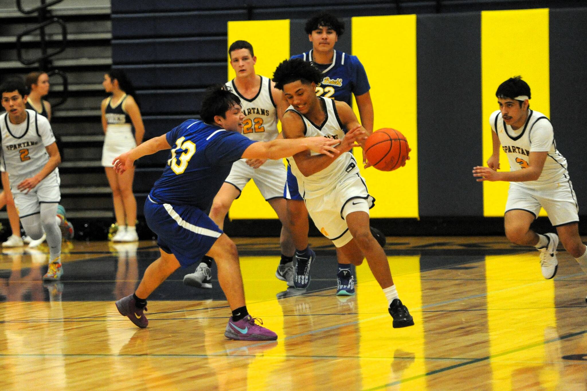 Lonnie Archibald/for Peninsula Daily News
Forks’ Bubba Hernandez-Stansbury drives around Chief Leschi’s Kevin Gallo-Paul Thursday night in Forks where The Spartans defeated the Warriors 84-23.