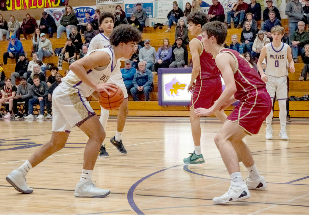 Sequim’s Jericho Julmist looks to drive against Kingston last week. The Wolves are 11-1 so far this season. In on the play are Solomon Sheppard, left, and Ethan Melnick (0). (Emily Mathiessen/Olympic Peninsula News Group)