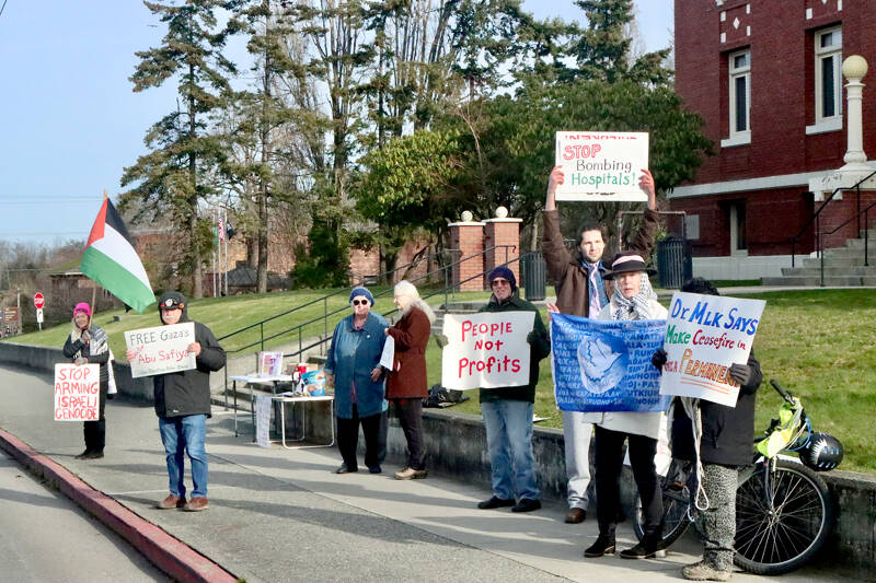 A group demonstrates in front of the Clallam County Courthouse on Lincoln Street in Port Angeles on Monday. The event, sponsored by the Clallam Palestine Action Group, was set on Martin Luther King Jr. day for a national mobilization for peace and justice, according to a press release. They were to focus on workers’ rights, immigrants’ rights, environmental justice and a free Palestine. (Dave Logan/for Peninsula Daily News)