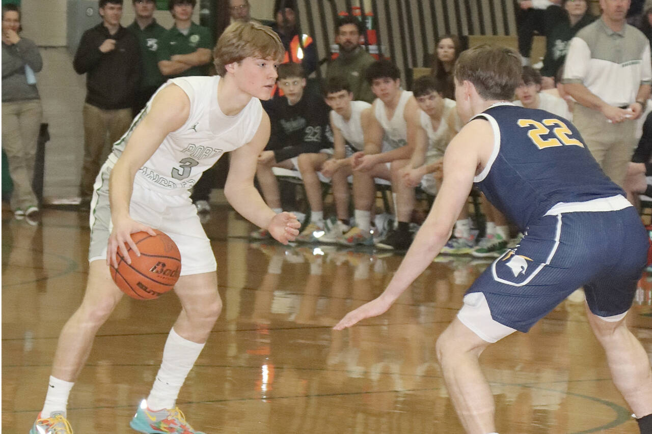 Port Angeles' Gus Halberg goes up against Bainbridge's Luke Johnson (22) on Tuesday in Port Angeles. The Roughriders hung tough with the Spartans, but fell 41-38. (Dave Logan/for Peninsula Daily News)