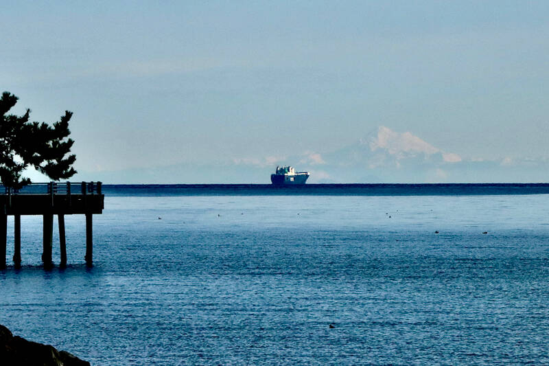 A ship passes by Mount Baker in the Strait of Juan de Fuca as seen from the Port Angeles City Pier on Wednesday morning. The weather forecast continues to be chilly this week as overnight temperatures are expected to hover around freezing. Daytime highs are expected to be in the mid-40s through the weekend. (Dave Logan/for Peninsula Daily News)