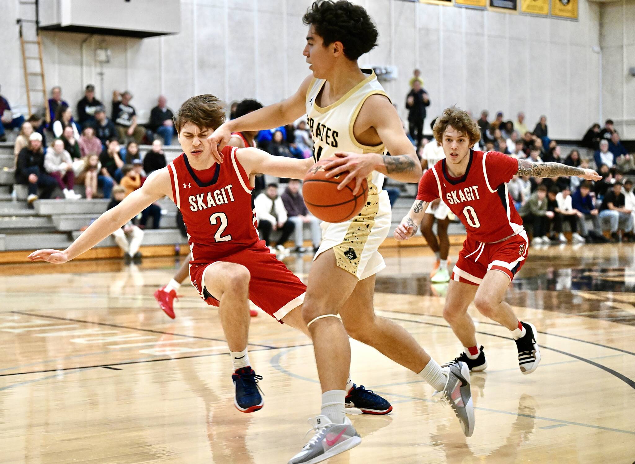 Jay Cline/Peninsula College Athletics 
Peninsula’s Isaiah Lopez makes contact with Skagit Valley’s Parker Nickerson, a 2024 Port Angeles High School graduate, during the Pirates’ 72-60 loss to the No. 1 ranked Cardinals.