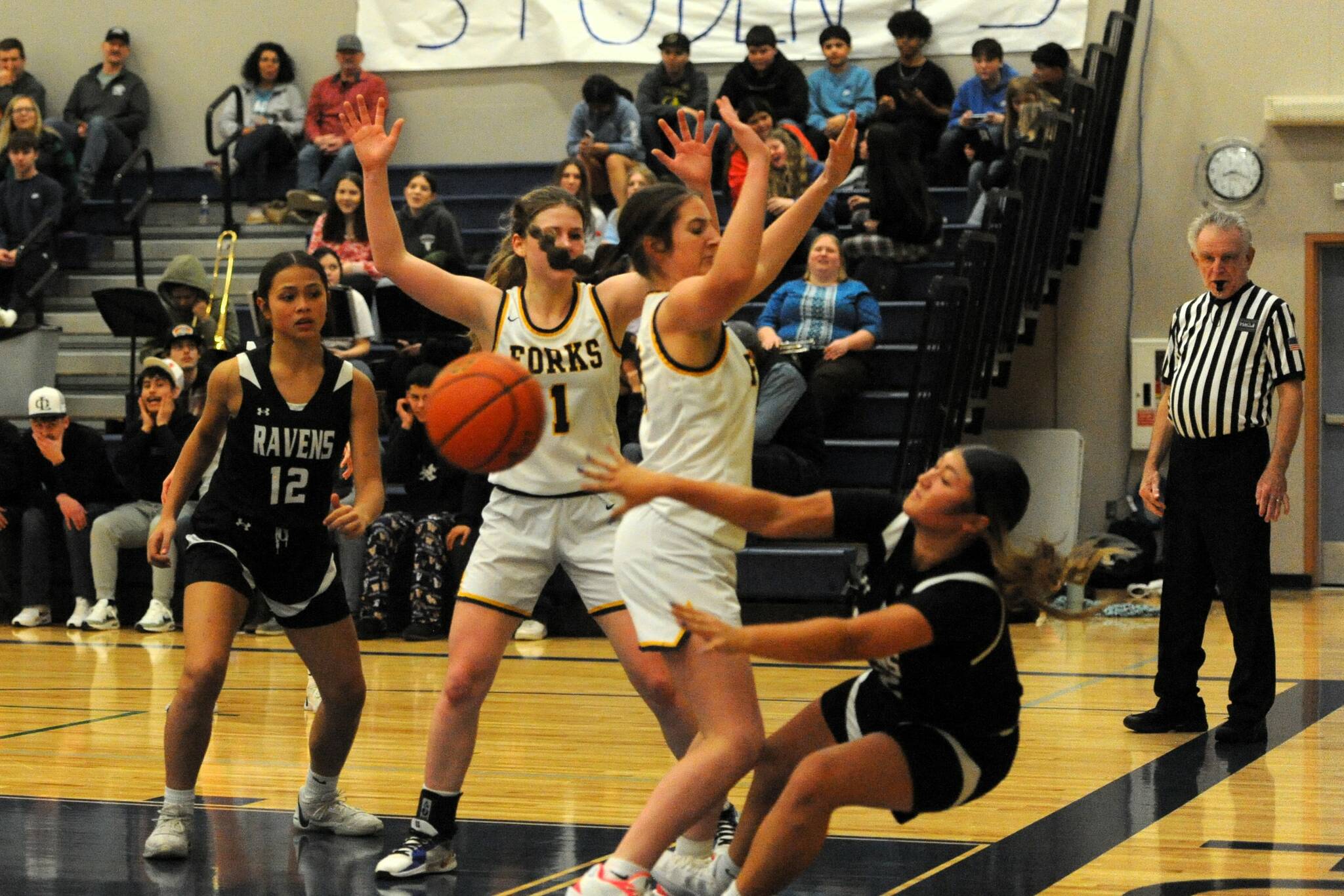 Lonnie Archibald/for Peninsula Daily News 
Forks’ Molly Hampton pressures Raymond-South Bend’s Berklee Morley while Raven Madisyn San (12) and Spartan Bailey Johnson (1) look on. The Ravens held off a late Forks rally to win 54-47.