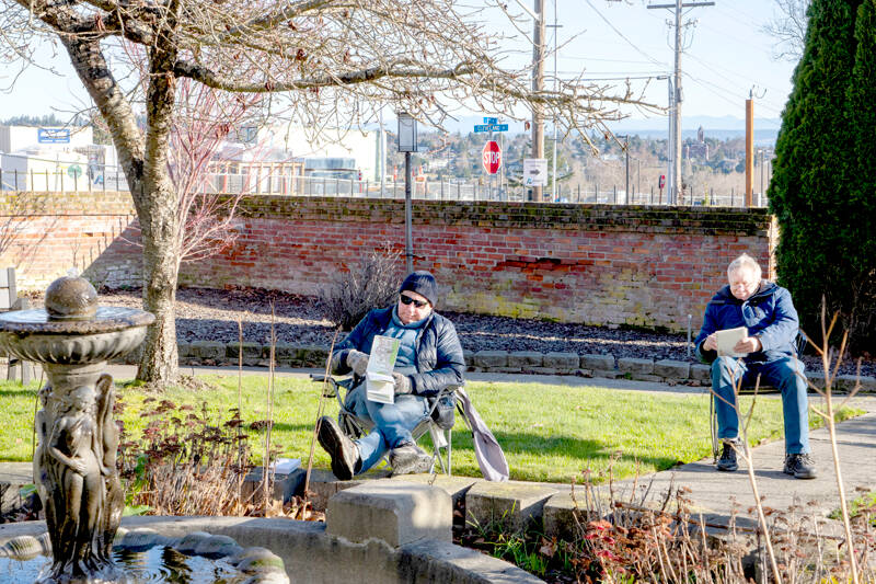 Claus Janssen, left, and Glenn Jansen, members of Port Townsend Urban Sketchers, sketch the fountain at Manresa Castle in Port Townsend. The group chooses a different location every month and meets at 10 a.m. and sketches until noon. (Steve Mullensky/for Peninsula Daily News)