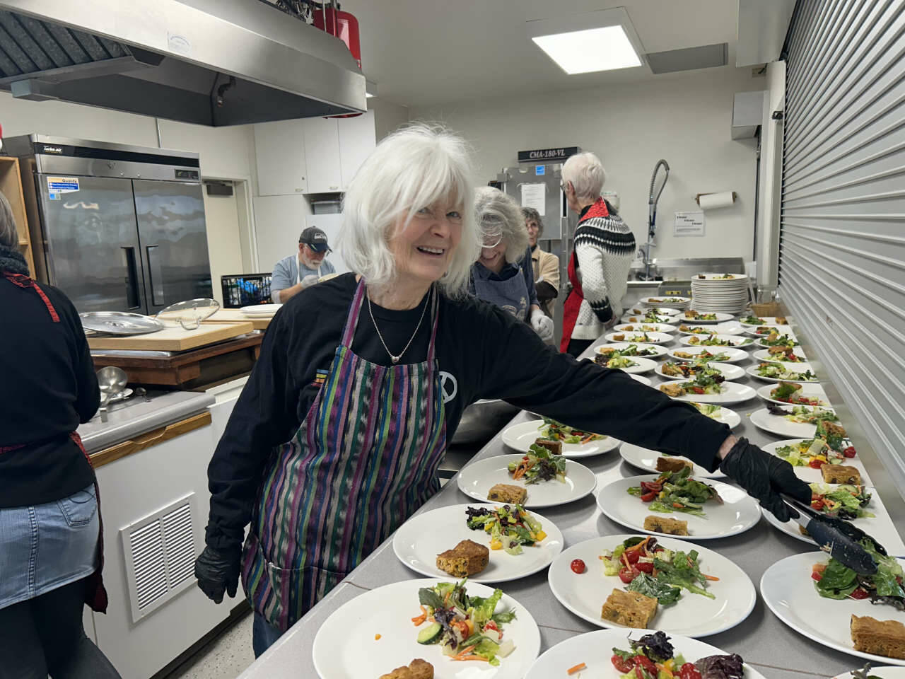 Kathy Cruz/Olympic Peninsula News Group
Mary Montgomery-Crumley dishes up helpings of salad at “Soup’s On.” Lunch also included a biscuit, two versions of minestrone soup, one vegetarian, one with chicken, and chocolate chip butterscotch bars.