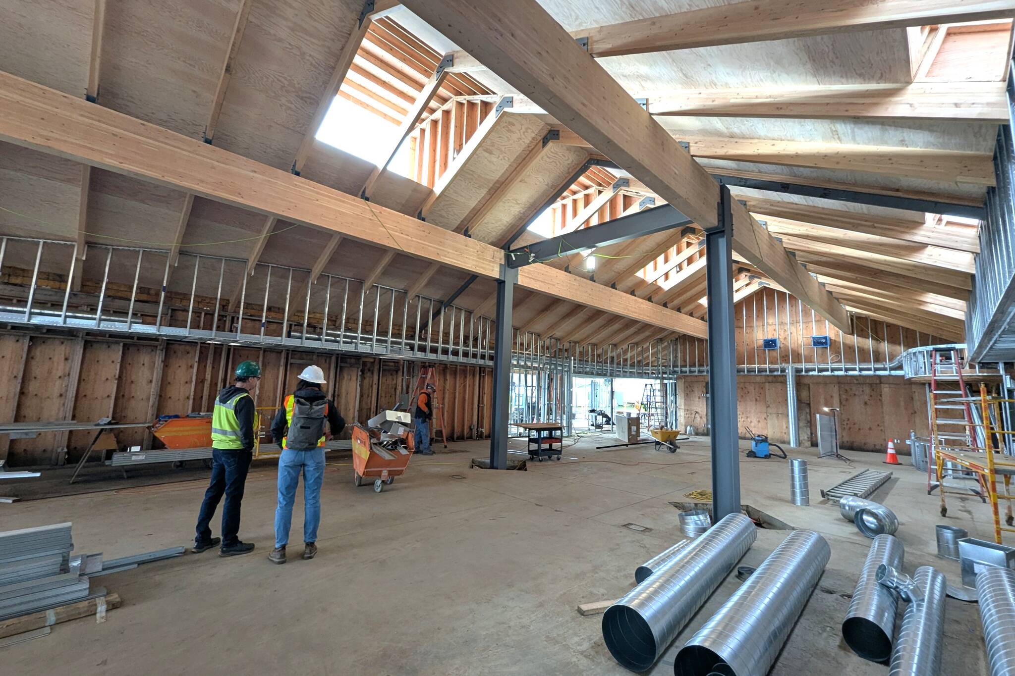 At a recent site visit, North Olympic Library System Facilities Manager Brian Phillips and SHKS Architect Pia Westen examine construction progress at the Sequim Library as it’s being renovated and expanded. NOLS leaders anticipate reopening the facility in June. (North Olympic Library System)