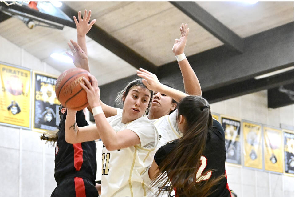 Peninsula College's Ryana Moss battles in the paint against Olympic's Allie Greene (2). Moss and Greene were teammates on Neah Bay's state championship team in 2023. (Jay Cline/Peninsula College)