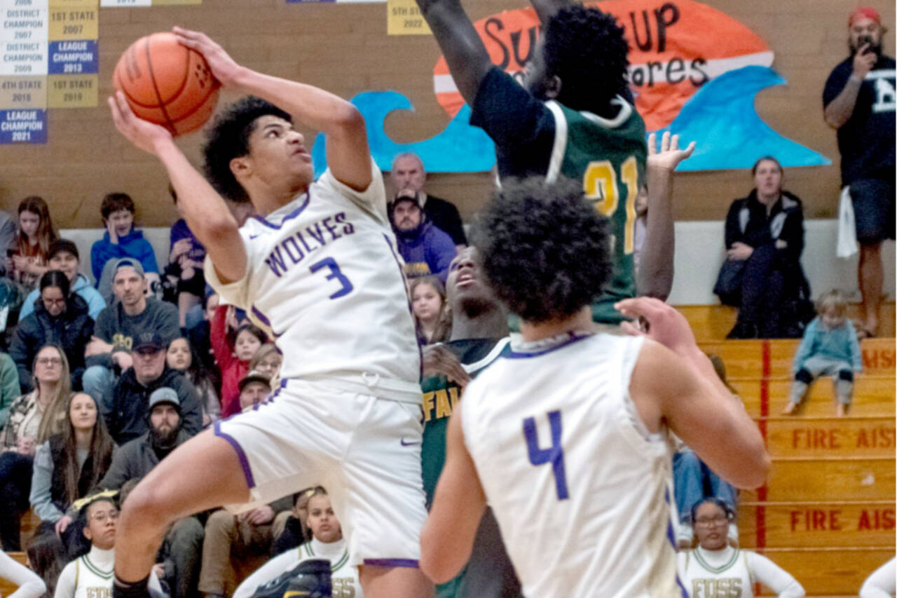 Sequim’s Solomon Sheppard goes up for a basket last week in a District 3 tournament game in Sequim against Foss. Sheppard had 14 points in a 56-46 win over Port Angeles on Saturday to help send the Wolves to the state tournament for the first time since 2012. In the foreground is Jericho Julmist (4). (Emily Mathiessen/Olympic Peninsula News Group)