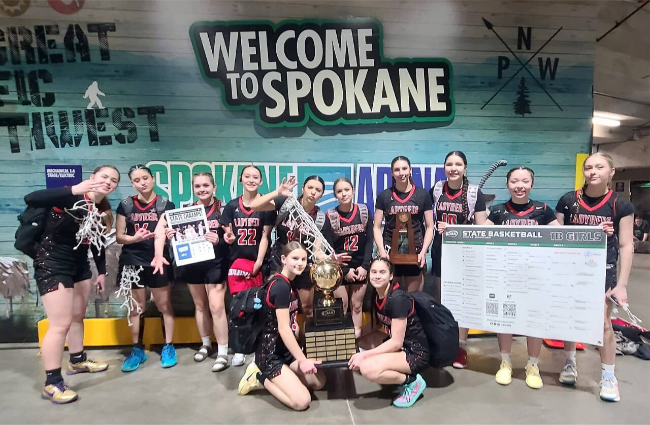 The Neah Bay girls basketball team celebrates its third straight state 1B championship in Spokane on Saturday. (Cherish Moss)